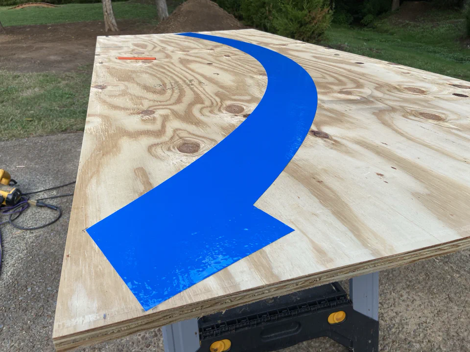 The transition curve, drawn in Illustrator and cut into vinyl, then transferred to the wood.