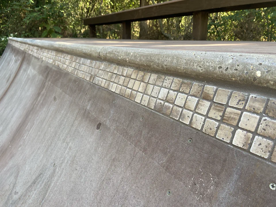 Fully grouted tile band under the coping.