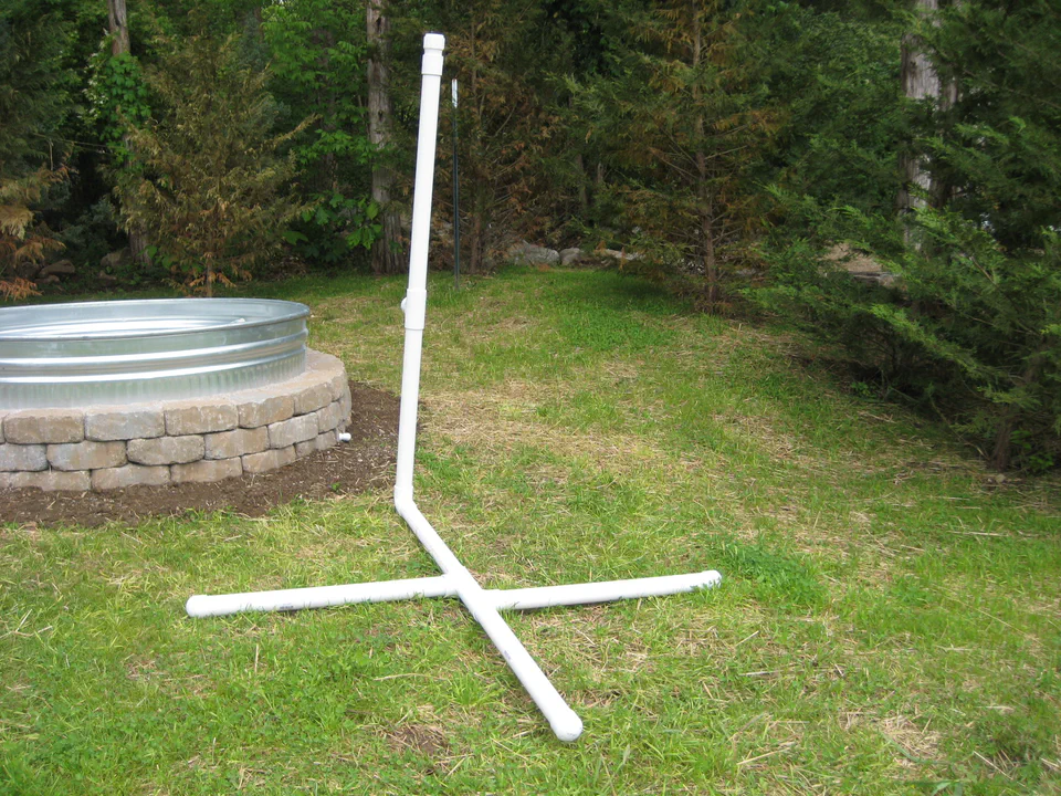 A free-standing PVC mast — the spine that would later carry the rain catcher above the bed.