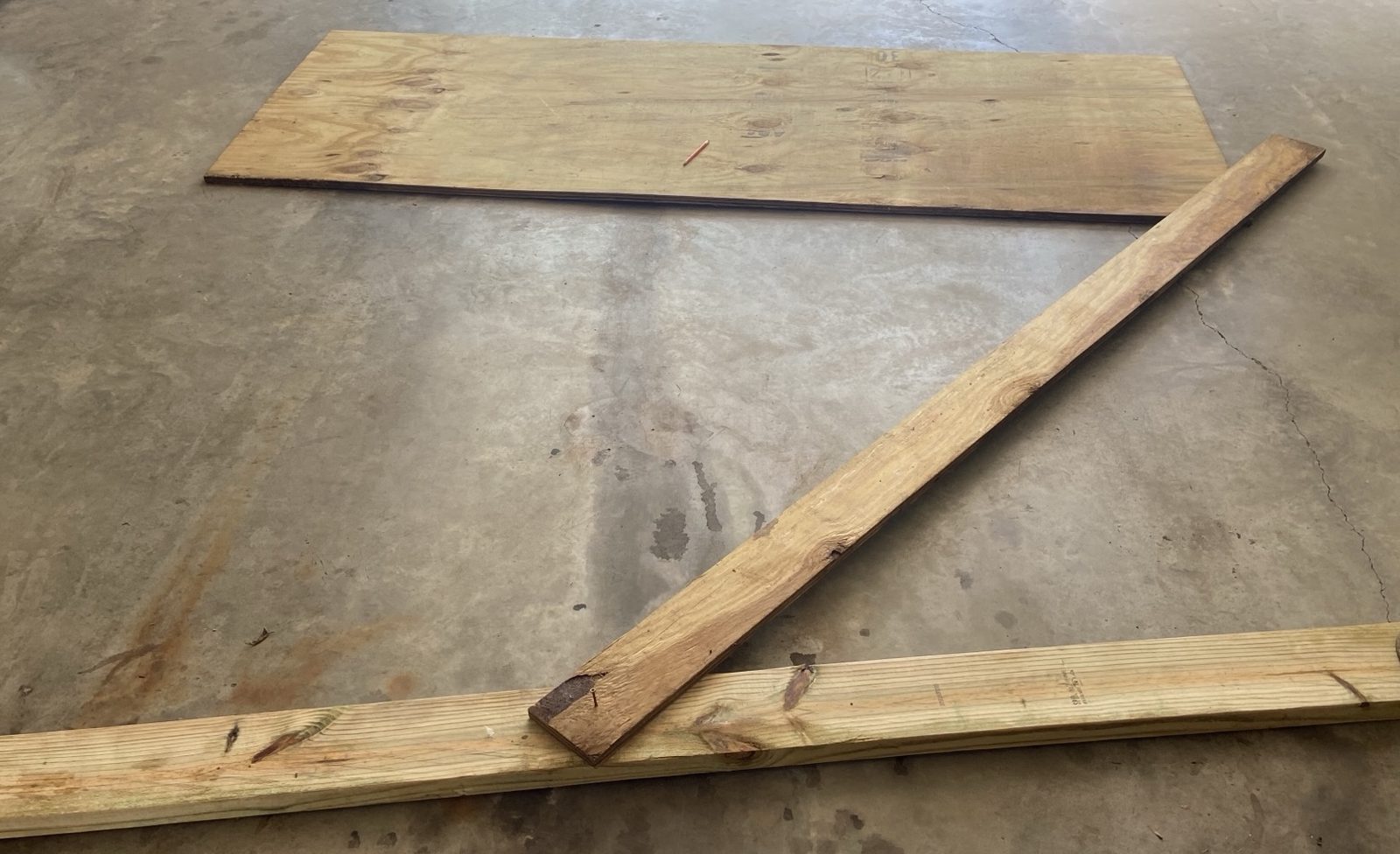 A batten screwed down at one end with a pencil at the other, scribing the corrected radius by hand.