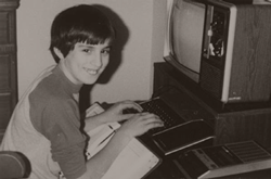 A younger version of Michael at a desk with early-90s computing equipment.